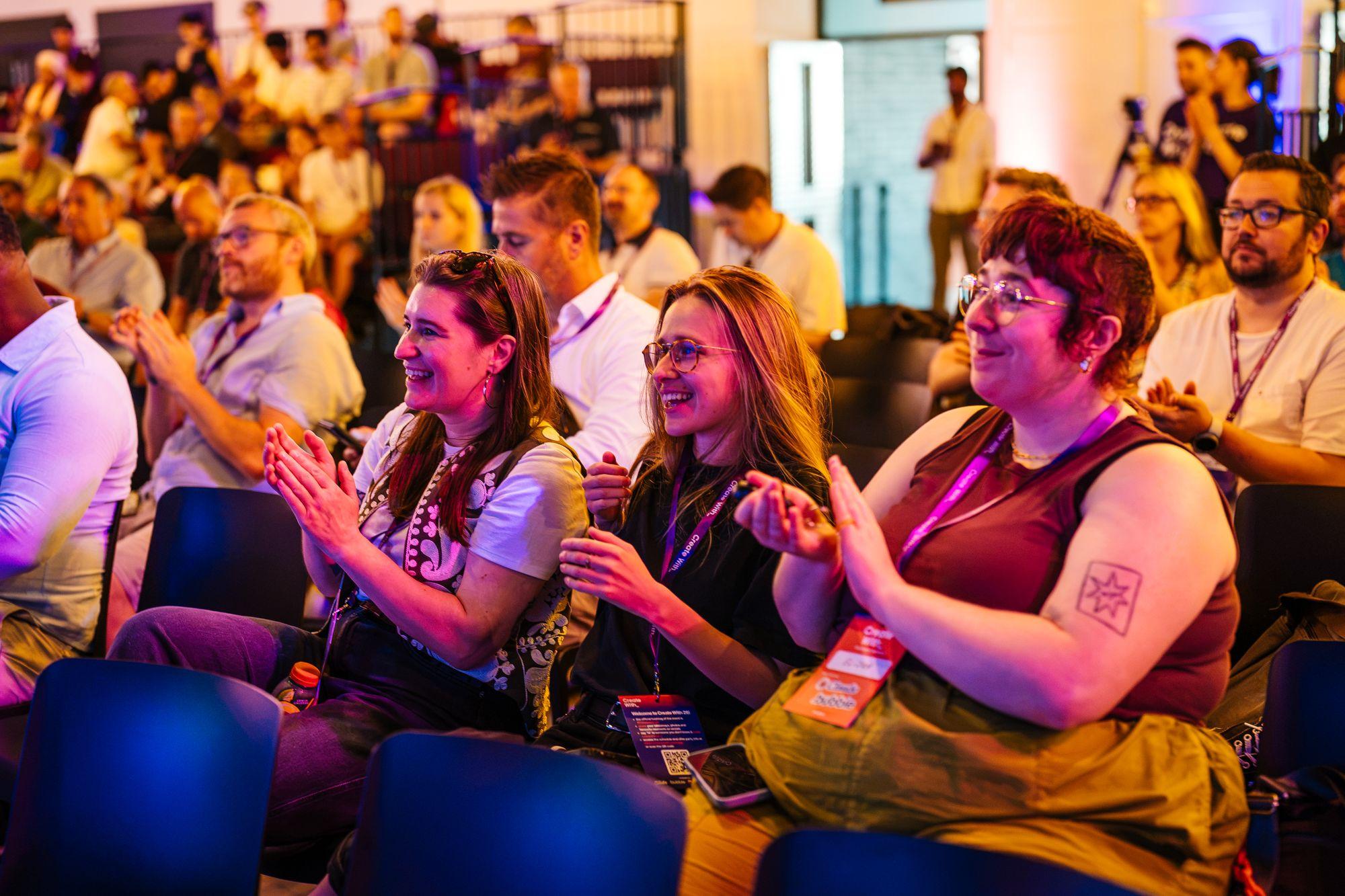 The audience laughing and applauding during a talk